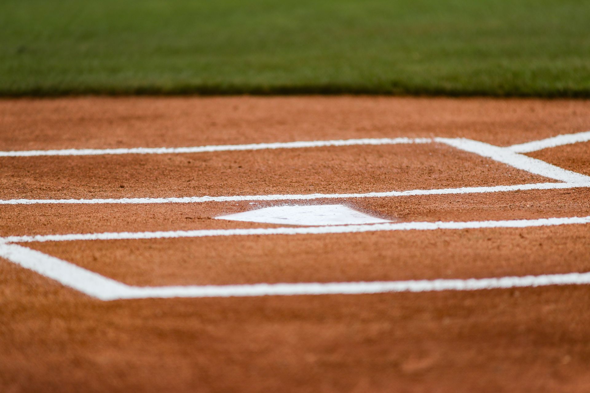 A close up of a baseball field with a base.