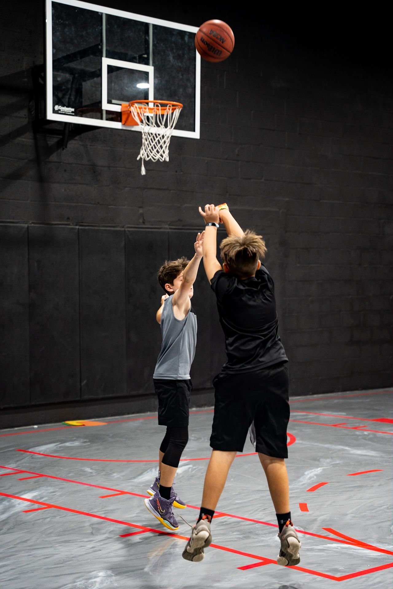 Youth basketball players training indoors at Vice City Basketball Academy’s Pinecrest summer camp.