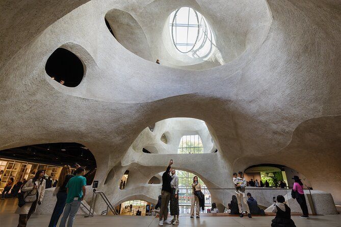 A group of people are standing in a large building