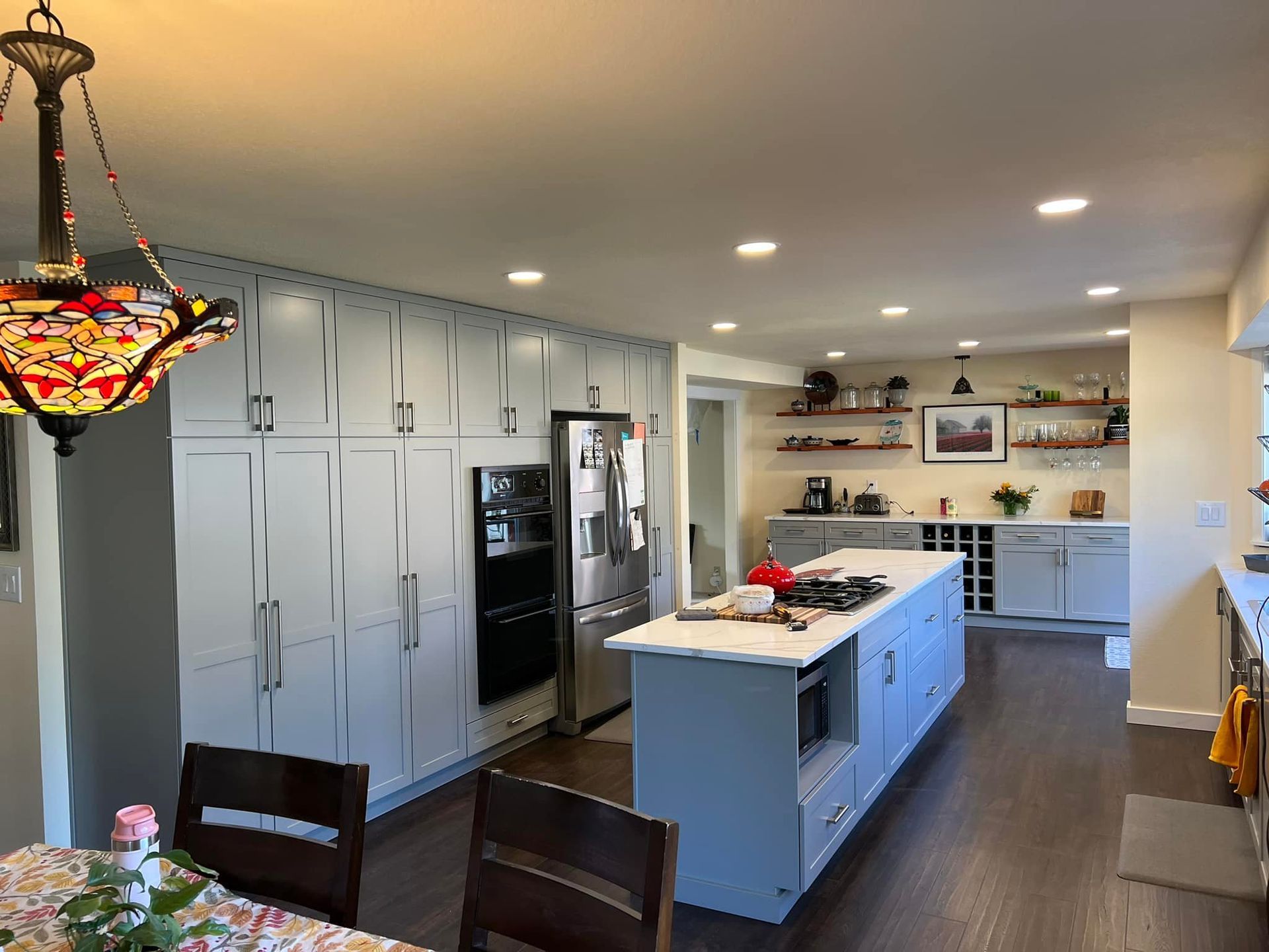 Kitchen with light gray cabinets, stainless steel appliances, and a central island.