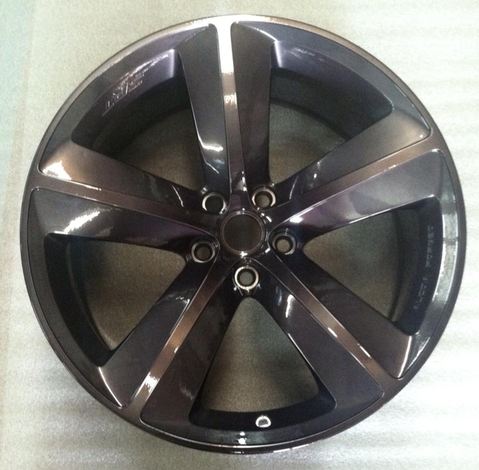 A close up of a black wheel with a silver rim