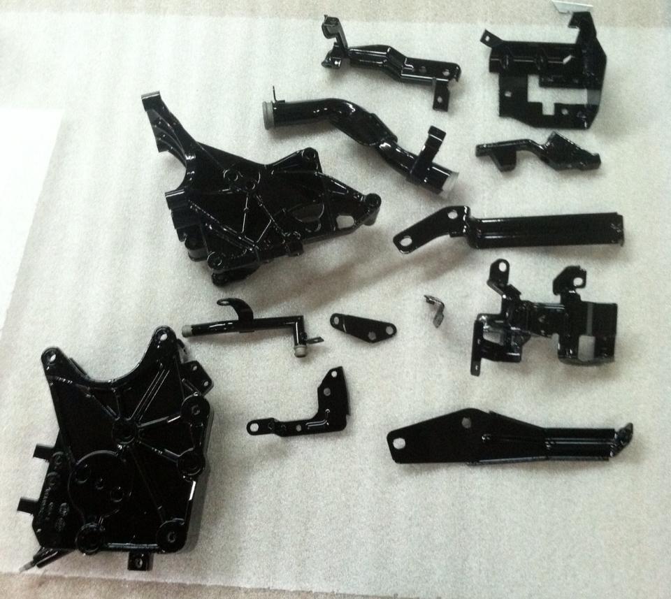 A bunch of black metal parts on a white surface