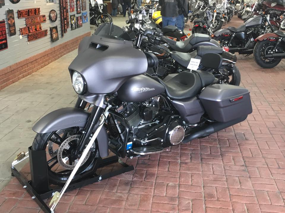 A row of harley davidson motorcycles in a showroom