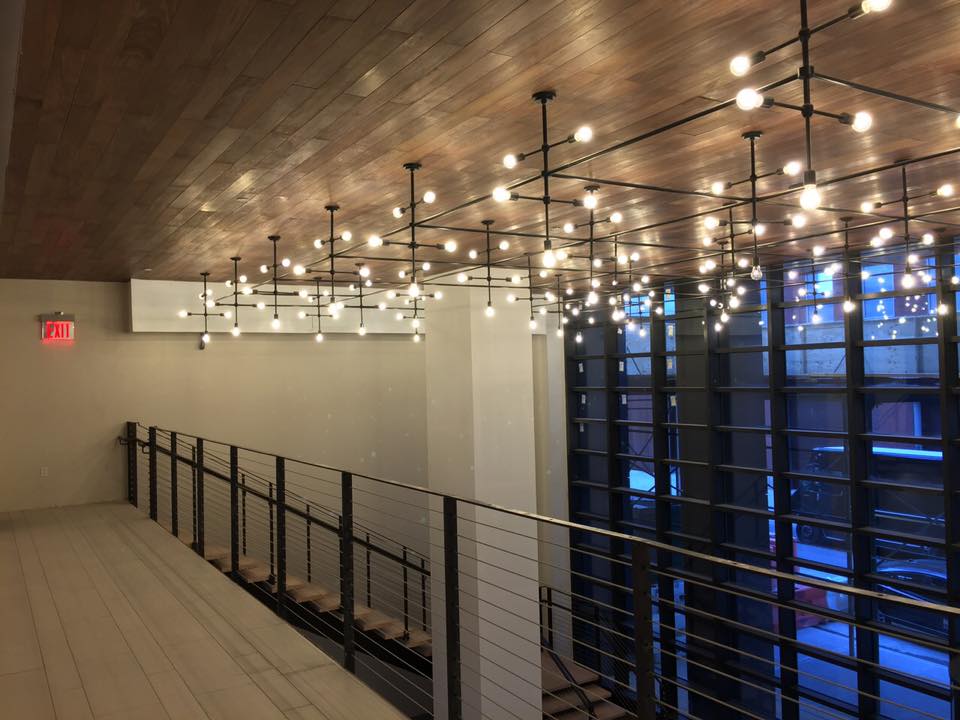 A room with a lot of lights hanging from the ceiling