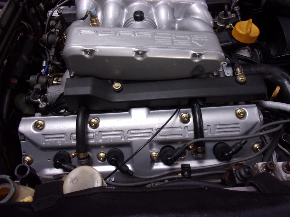 A close up of a porsche engine in a car