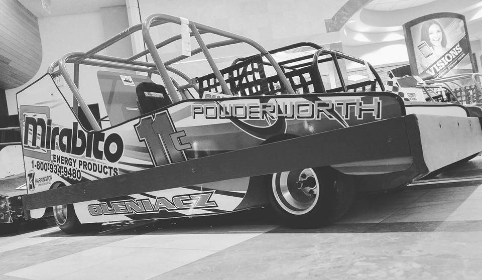 A black and white photo of a race car with mirabito written on the side.