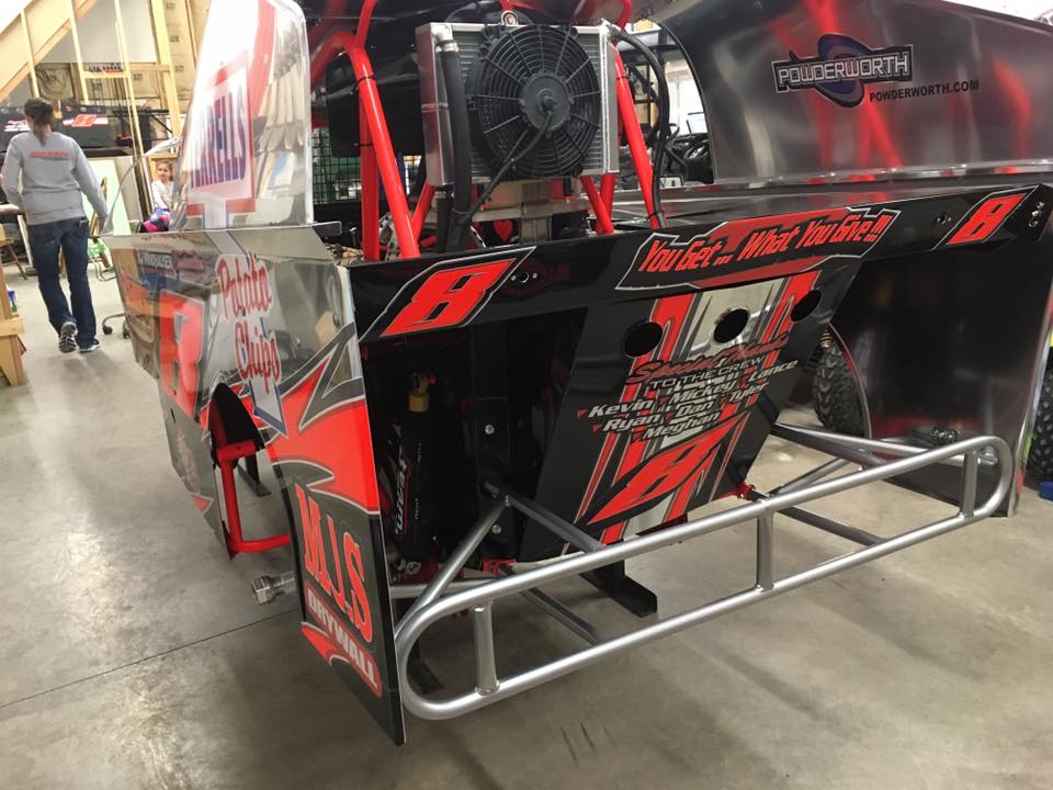 A red and black race car with the number 8 on it