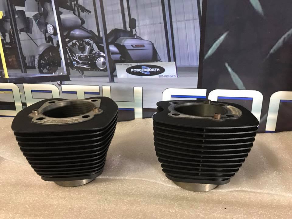 Two black cylinders are sitting next to each other on a table