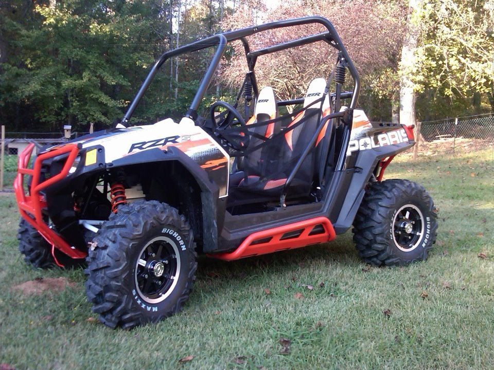 A polaris atv is parked in the grass