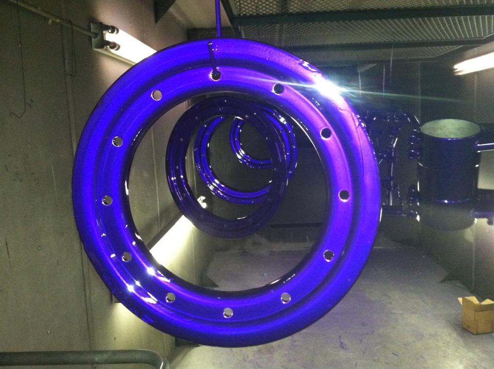 A bunch of purple rings are hanging from the ceiling