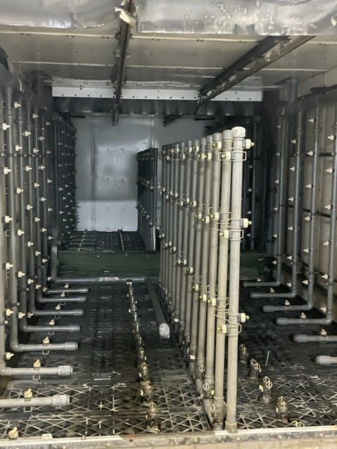 A row of pipes are lined up in a room.