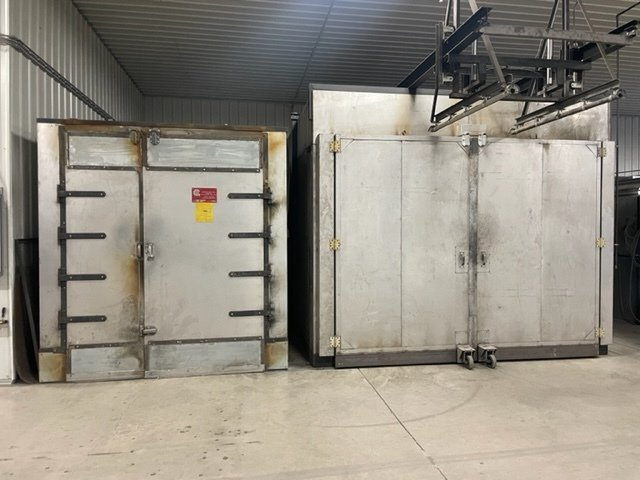 Two metal boxes are sitting next to each other in a room.