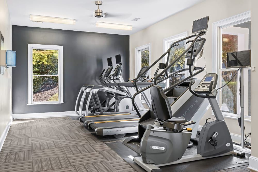 a gym with a lot of treadmills and exercise bikes at Marquis on Edwards Mill in Raleigh, NC. 