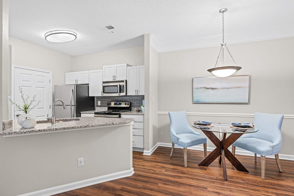a kitchen and dining room in a house with a table and chairs at Marquis on Edwards Mill in Raleigh, NC. 