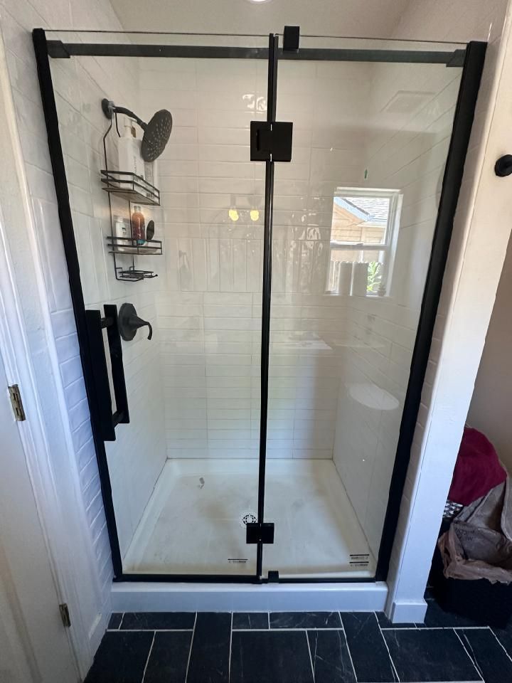 Frameless glass shower door with matte black hardware professionally installed by A1 Handyman in Boise, ID 