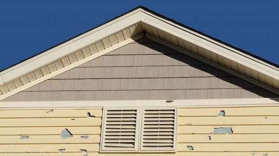 Damaged exterior siding with peeling paint on a Boise home, in need of professional siding repair by A1 Handyman.