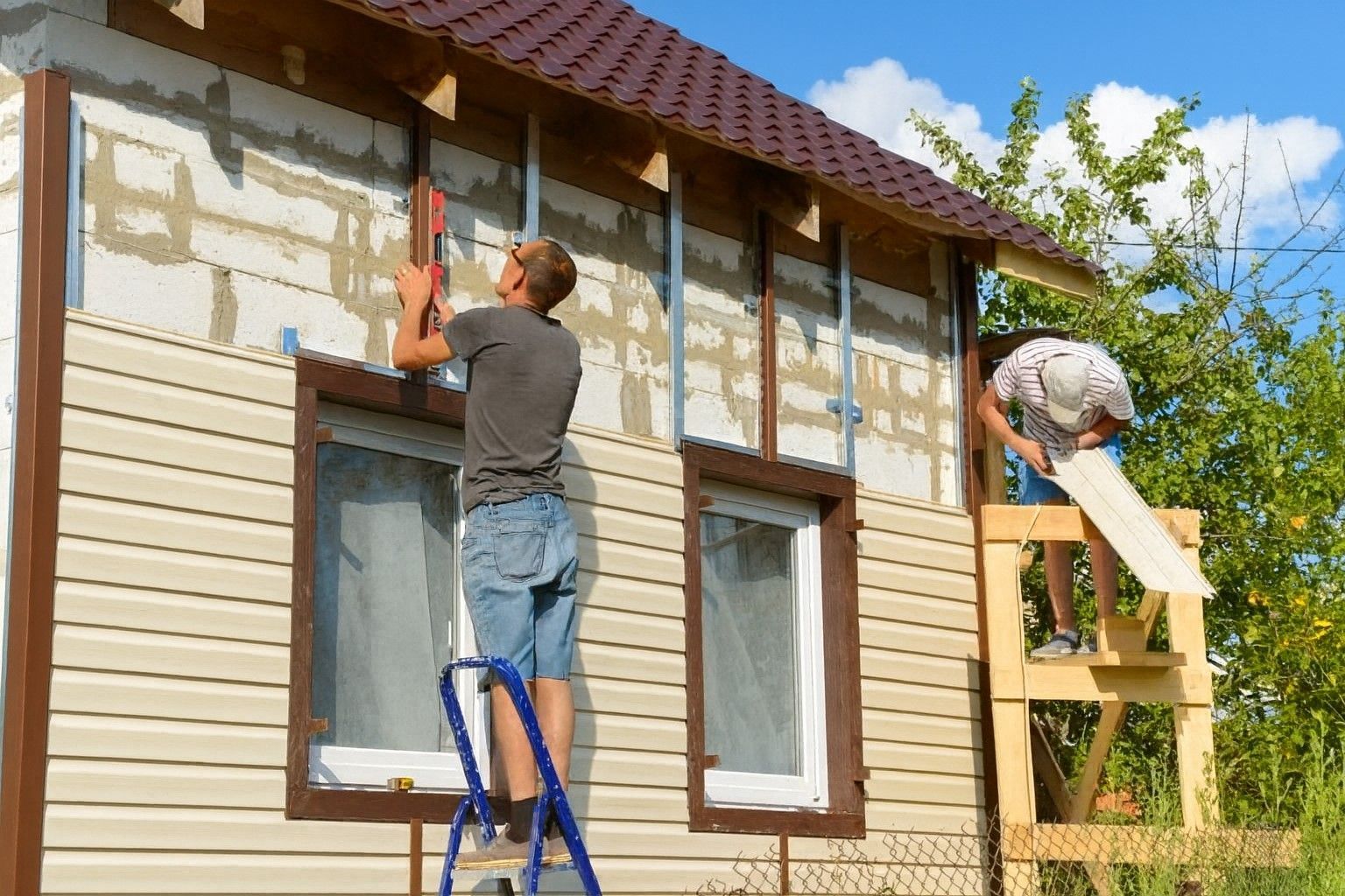 Two contractors working on wood siding installation on a Meridian, Idaho home.