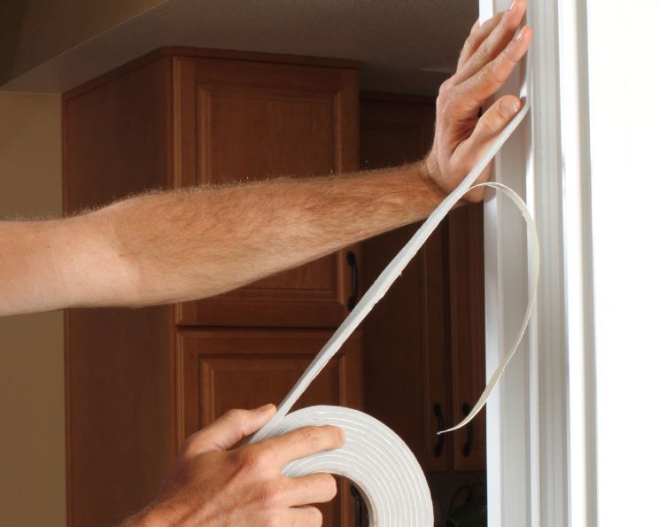 Applying  weather stripping to door | Boise, ID |