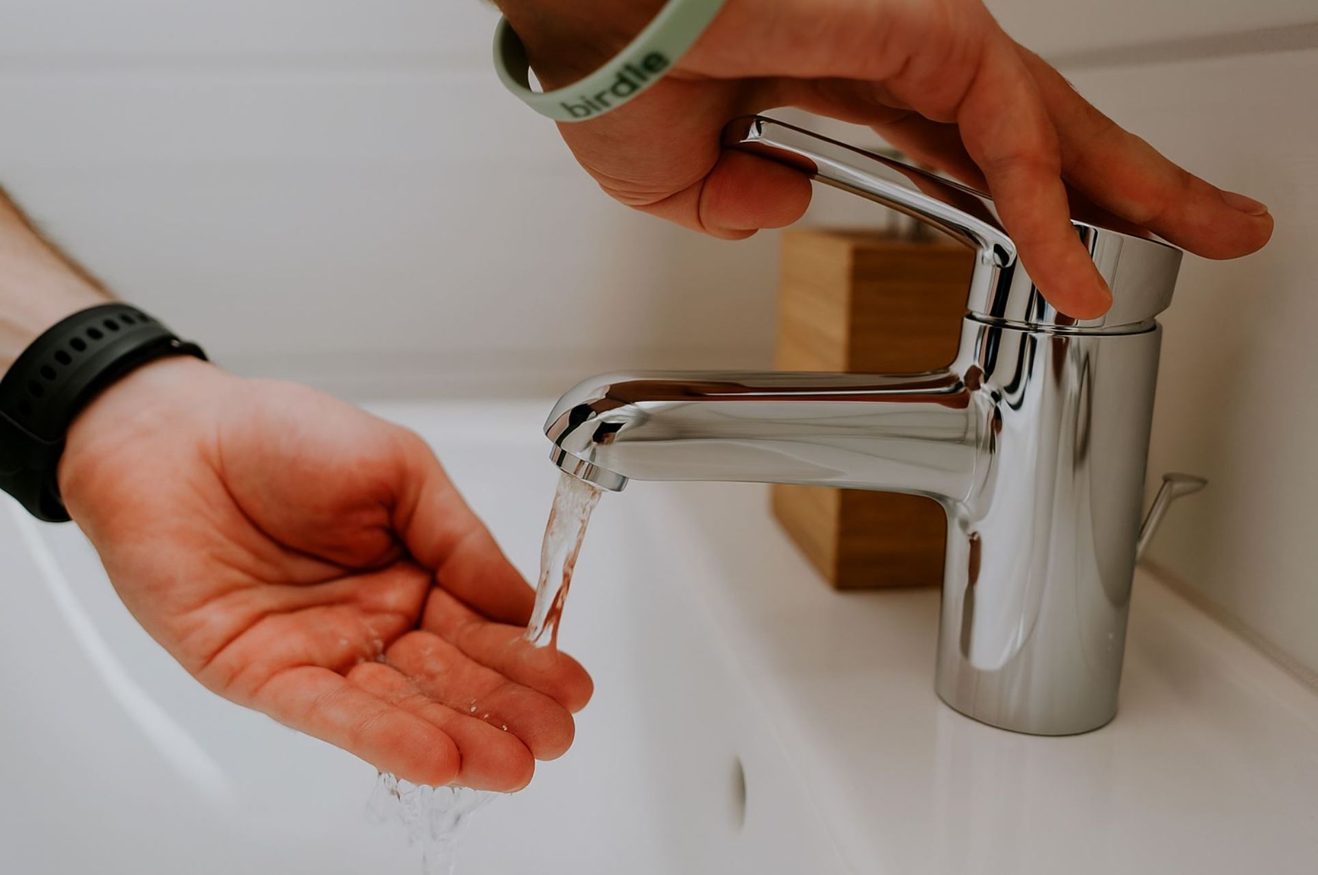 Water running from a newly installed chrome faucet during a faucet repair service by A1 Handyman in Boise, ID.