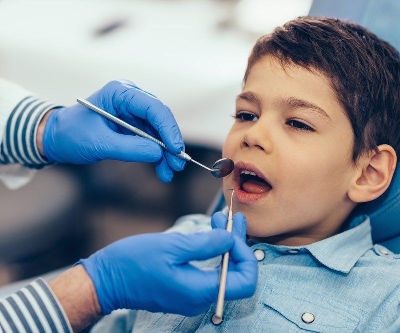 boy getting teeth examined