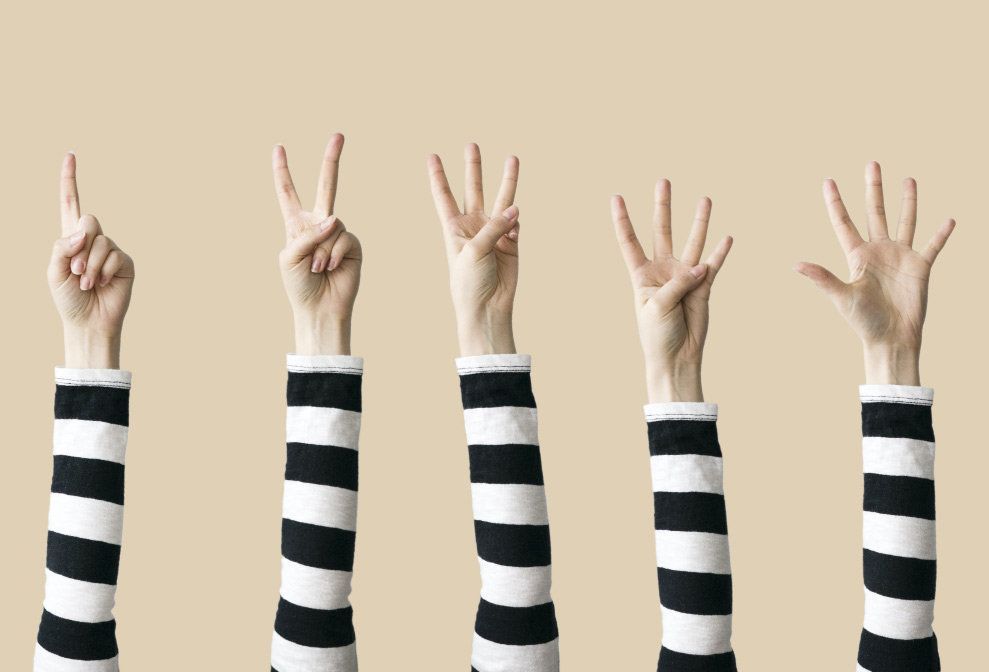 A group of people are raising their hands in the air.
