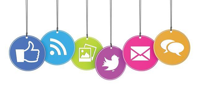 A row of colorful social media icons hanging from strings.