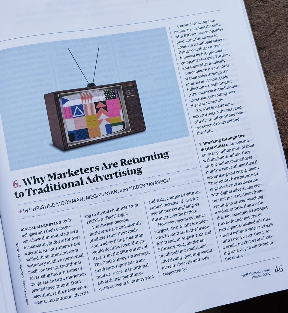 A book is open to a page that says why marketers are returning to traditional advertising