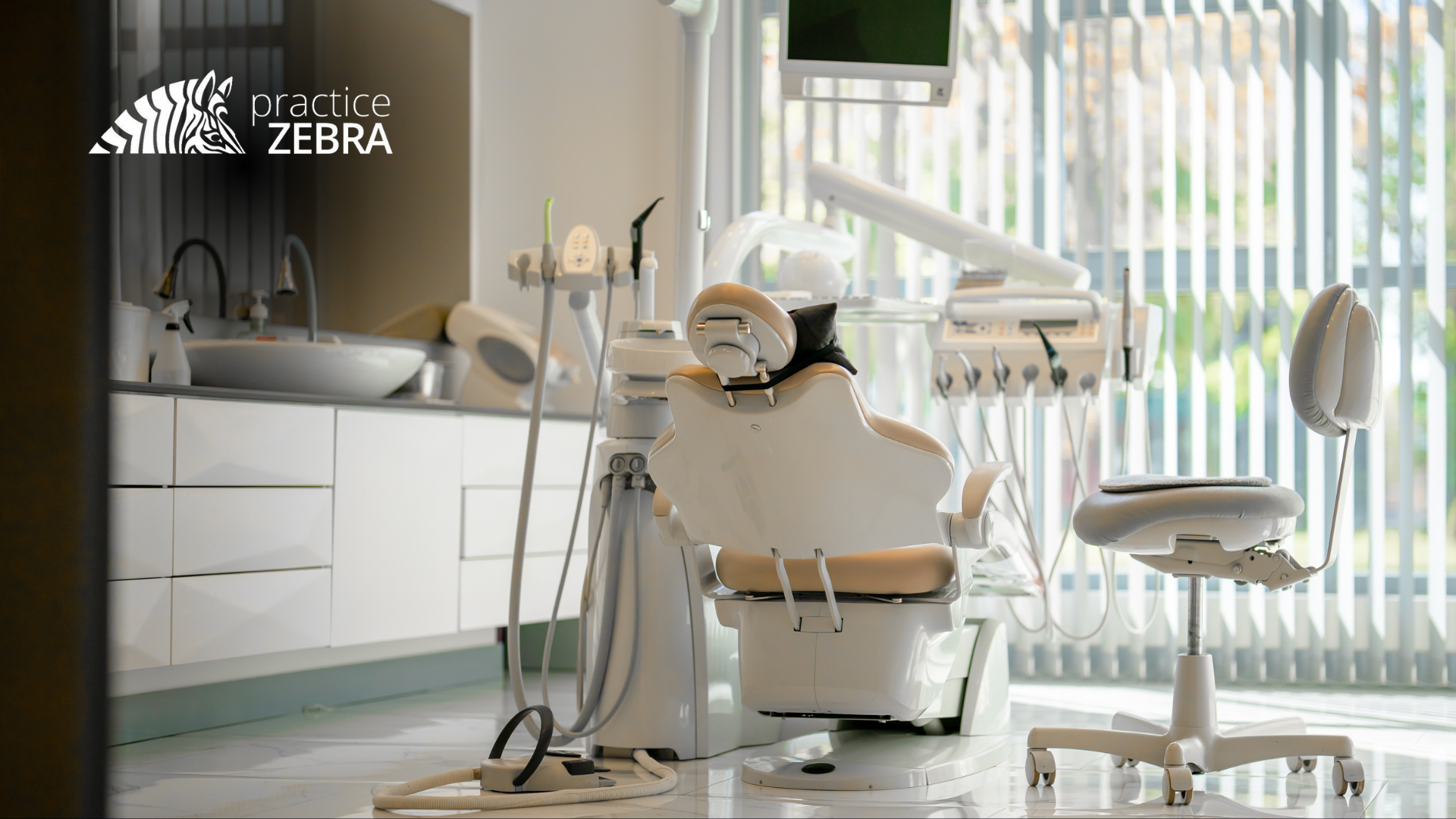 A dental office with a dental chair and a sink.