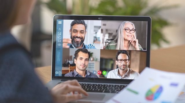 A group of people are having a video call on a laptop computer.