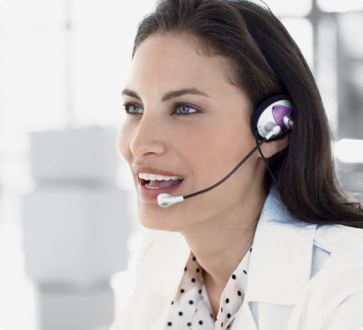 A woman wearing a headset is smiling at the camera.