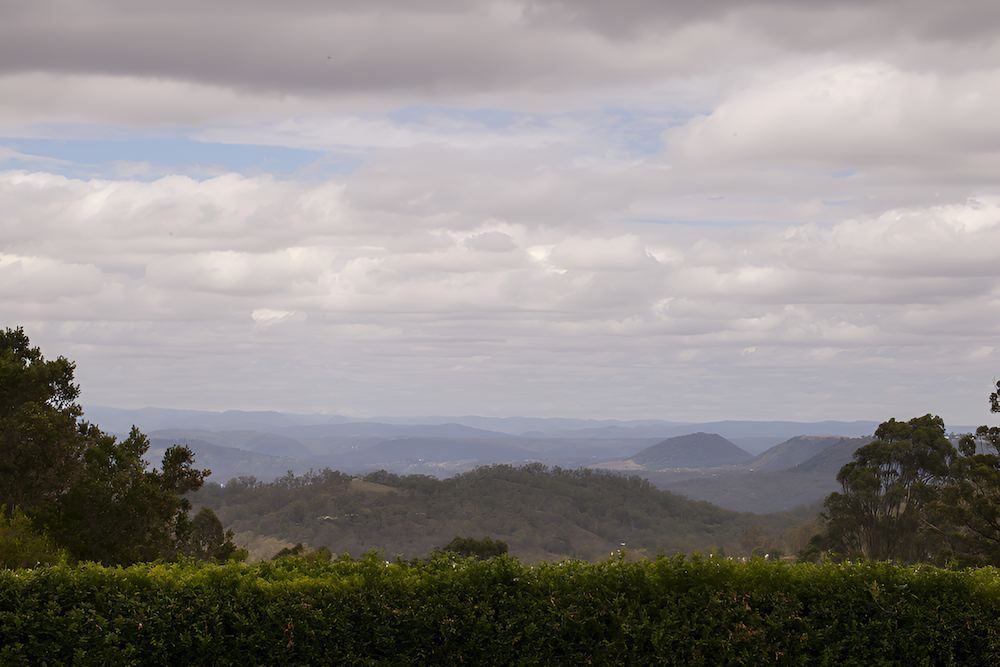 A View of a Mountain Range With Trees in the Foreground— Balzers Removals and Carrying in Lockyer Valley, QLD