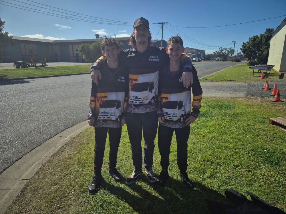 Three Young Men Are Posing For A Picture While Wearing Shirts With Trucks On Them — Balzers Removals and Carrying in Helidon, QLD