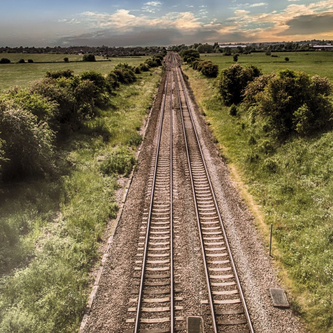 A train track going through a grassy field. Old Union Pacific Train Depot.