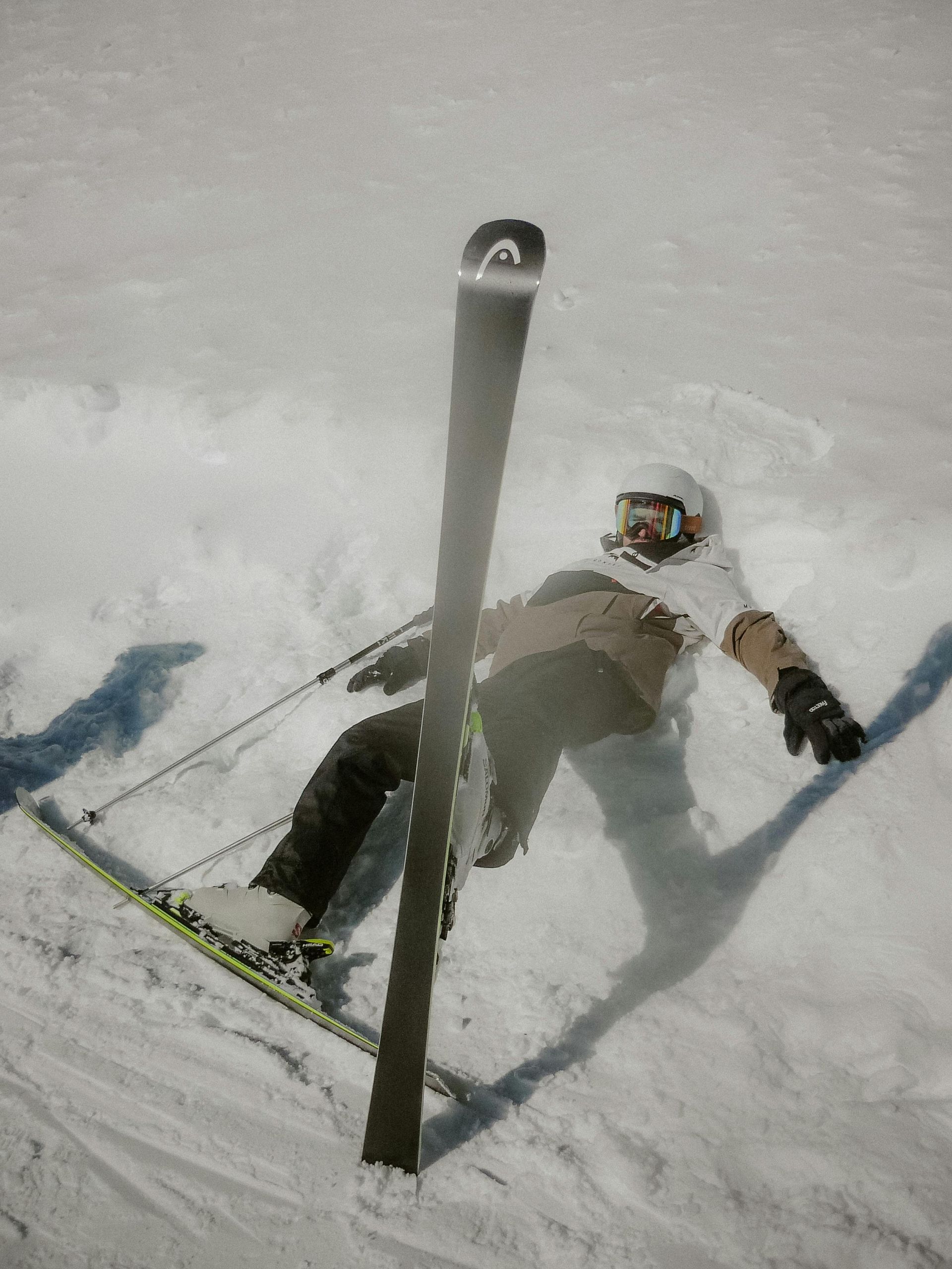 A skier lying on the snow after a fall, a common scenario where slip and fall attorneys can assist with compensation claims.