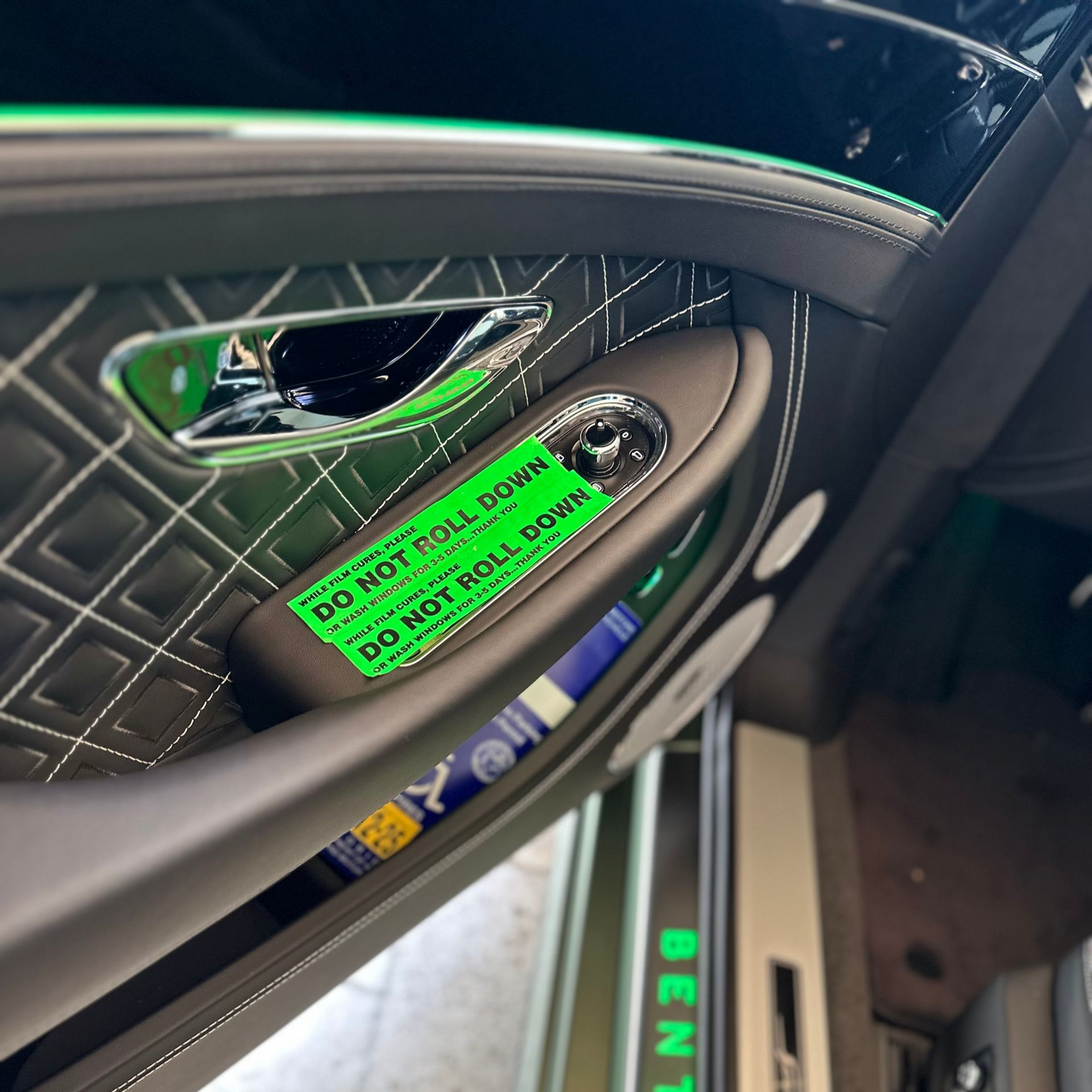 White Porsche SUV parked inside a showroom.