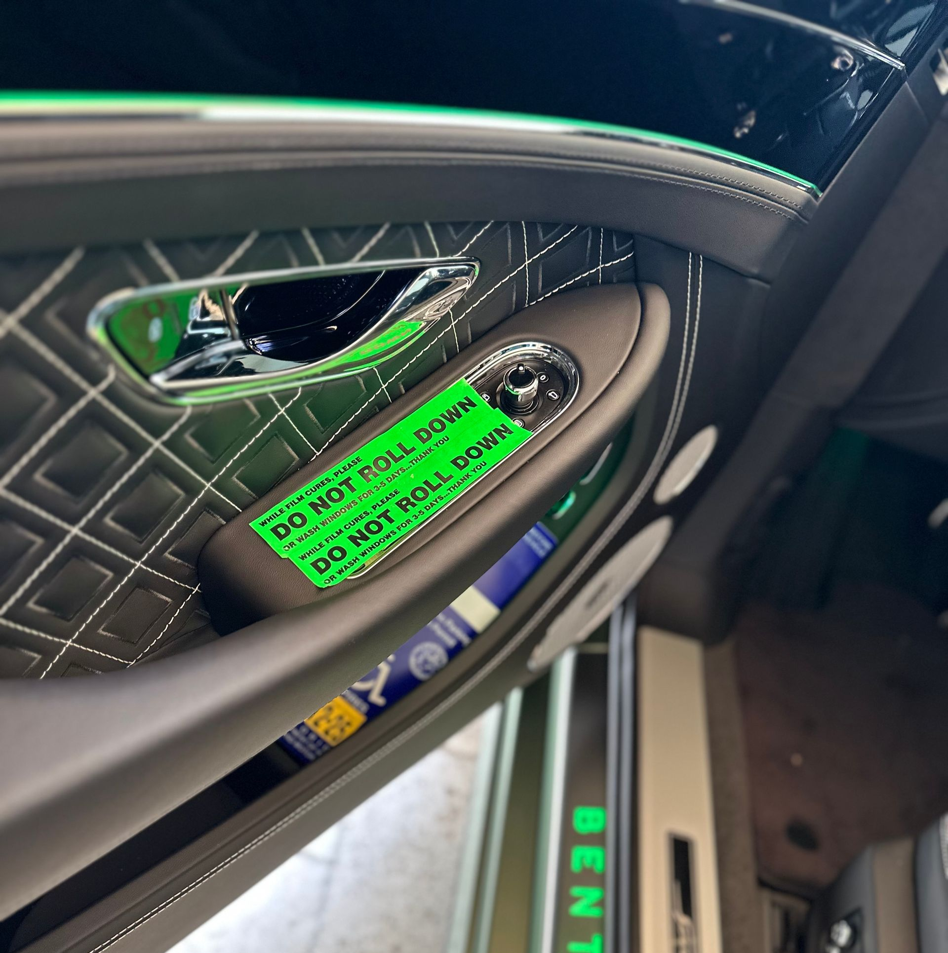 Interior car door with a sticker that says 