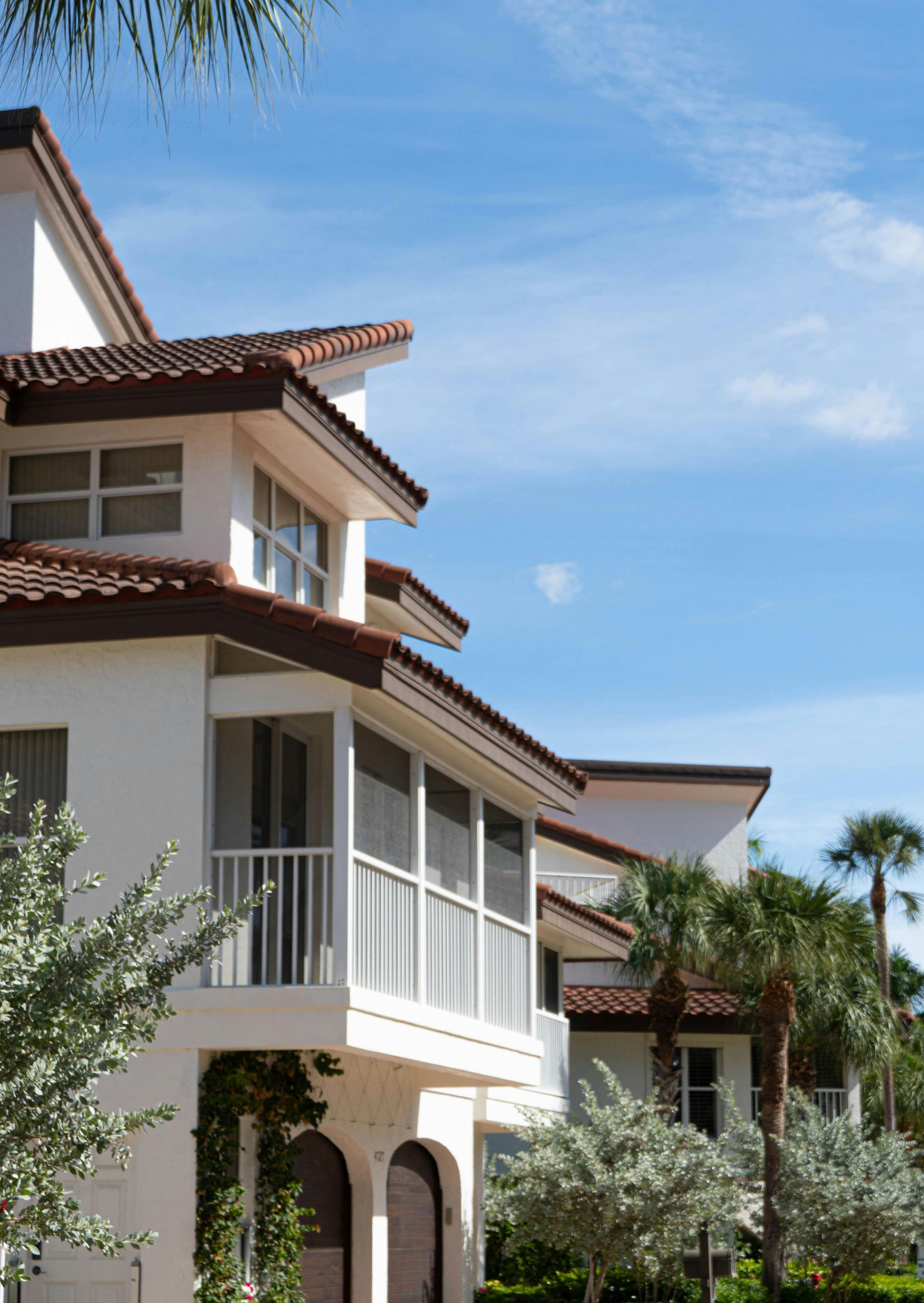 Dark gray modern home with patio, seating, and wooden accent.