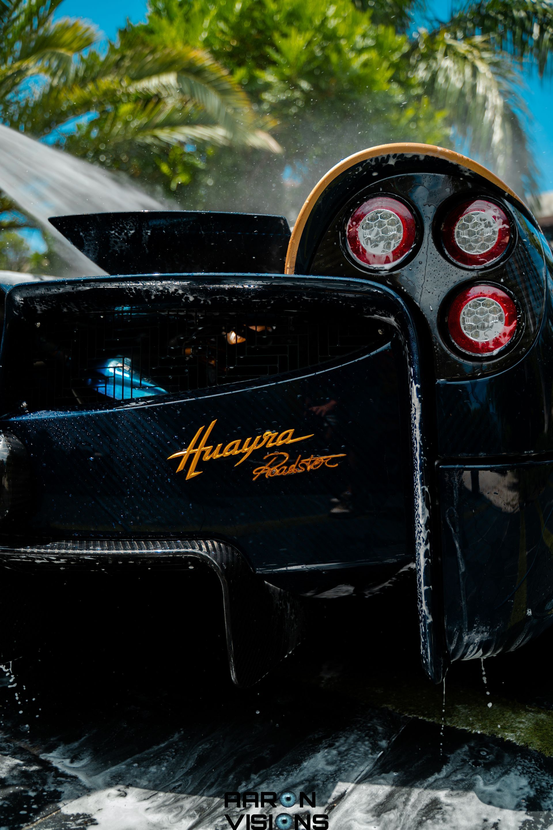 Black Pagani Huayra Roadster being washed; gold script 
