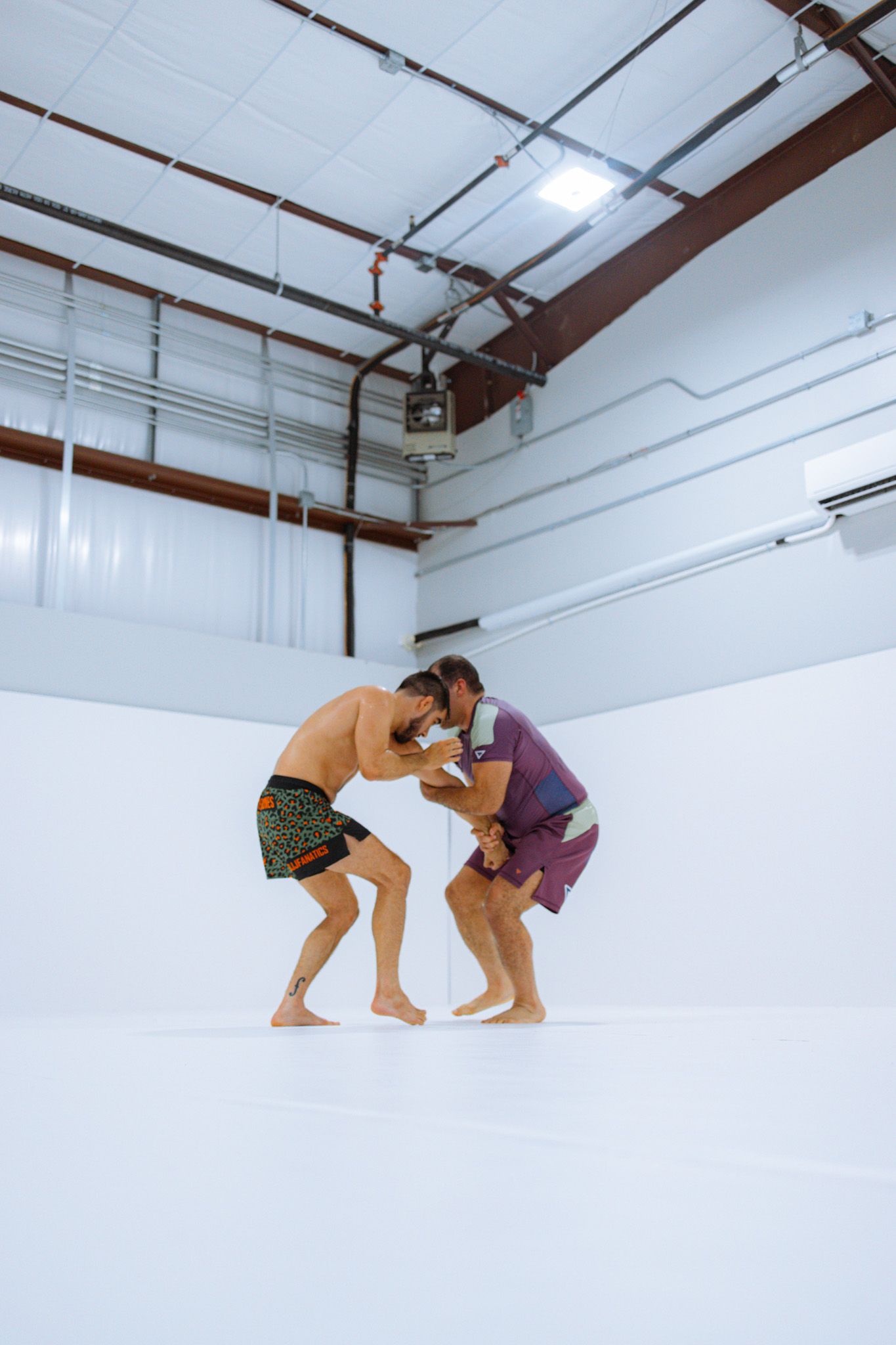 Adult students rolling in class at Jiu Jitsu Hub in Georgetown, Texas, building fitness and stress.