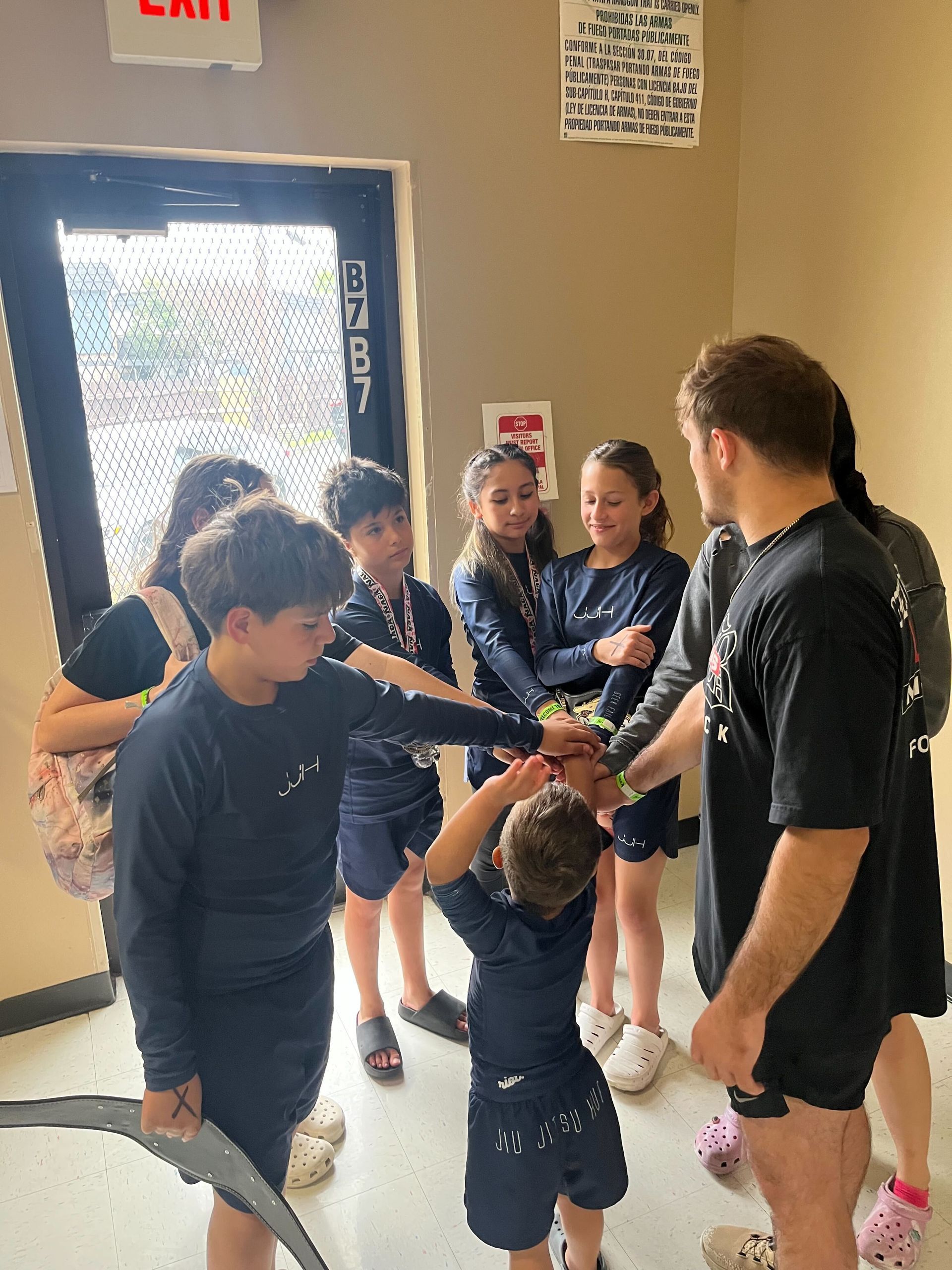 Adults and kids practicing No-Gi grappling at Jiu Jitsu Hub in Georgetown, Texas to build practical 