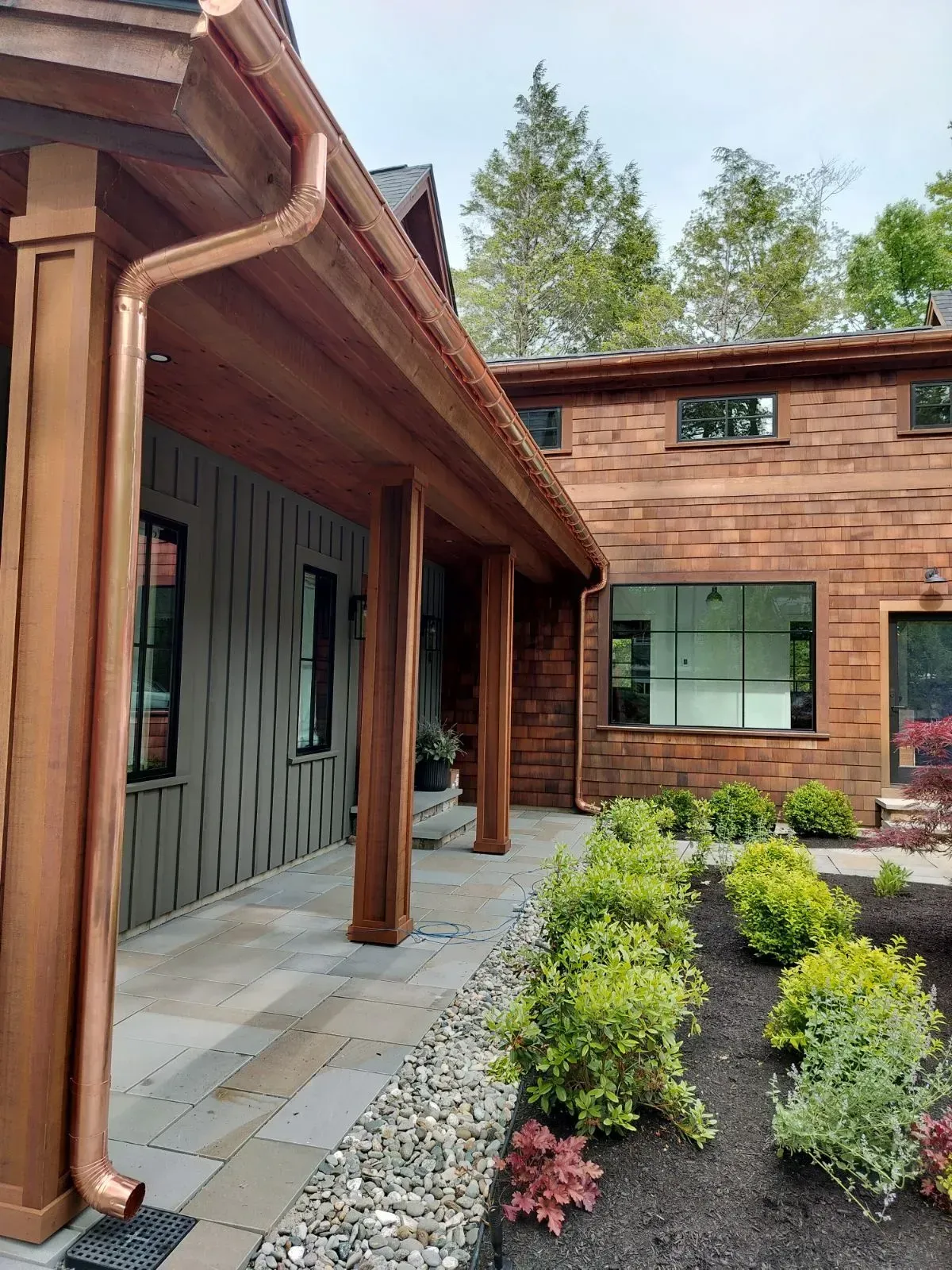 A house with a copper gutter on the side of it.
