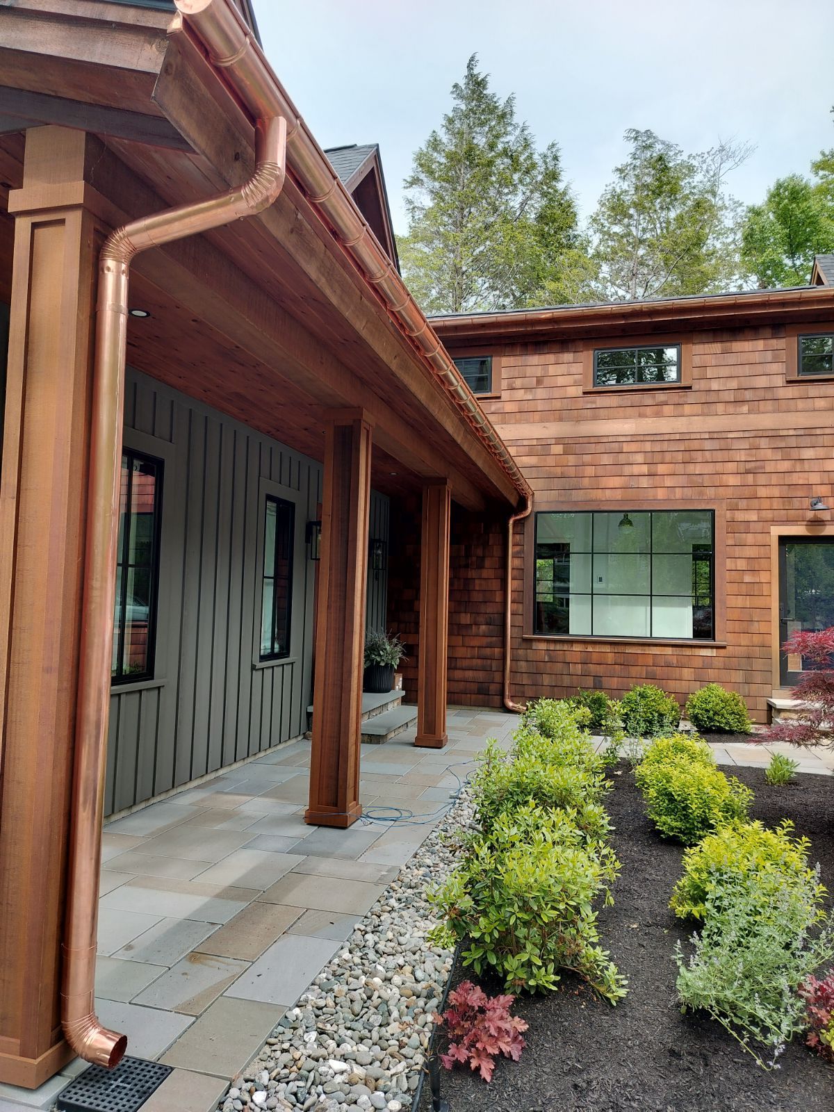 A house with a copper gutter on the side of it.