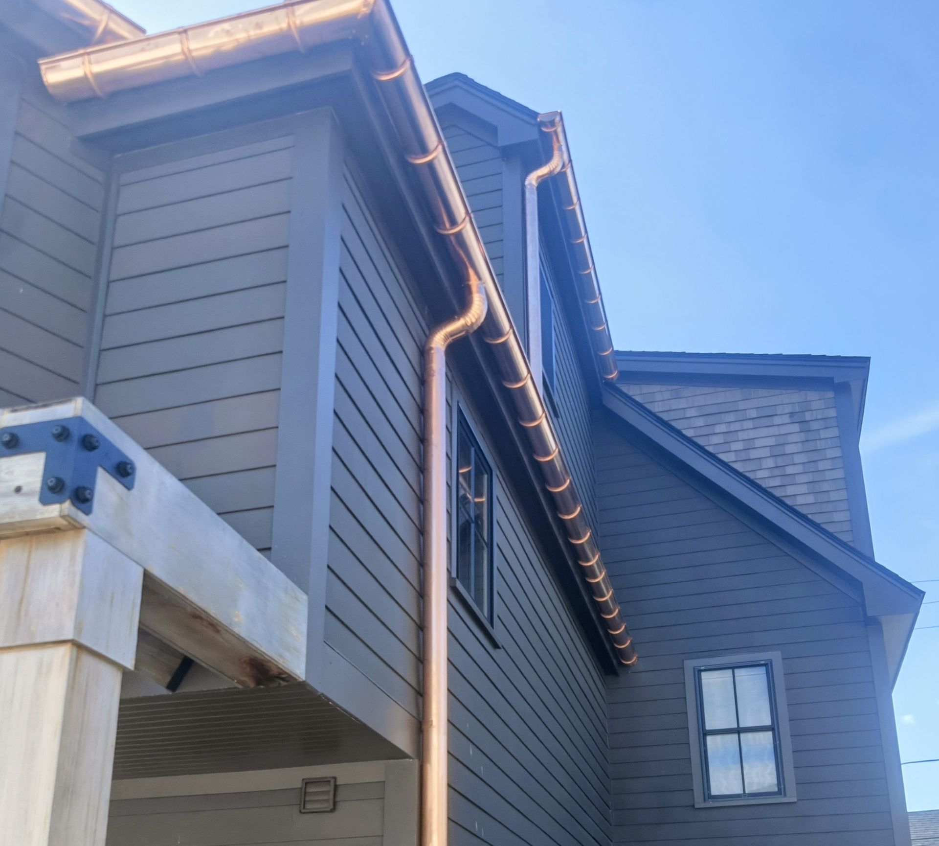 Seamless copper half-round gutter and downspout installed  New Hampshire home