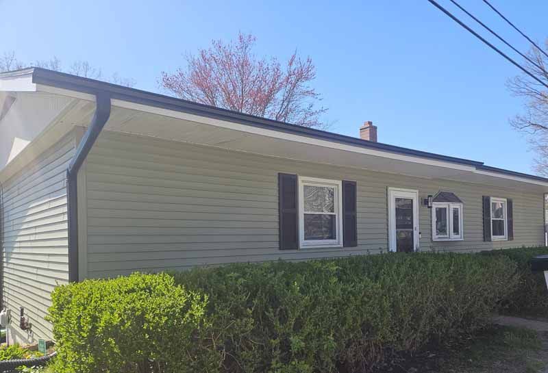 A house with a gutter on the side of it