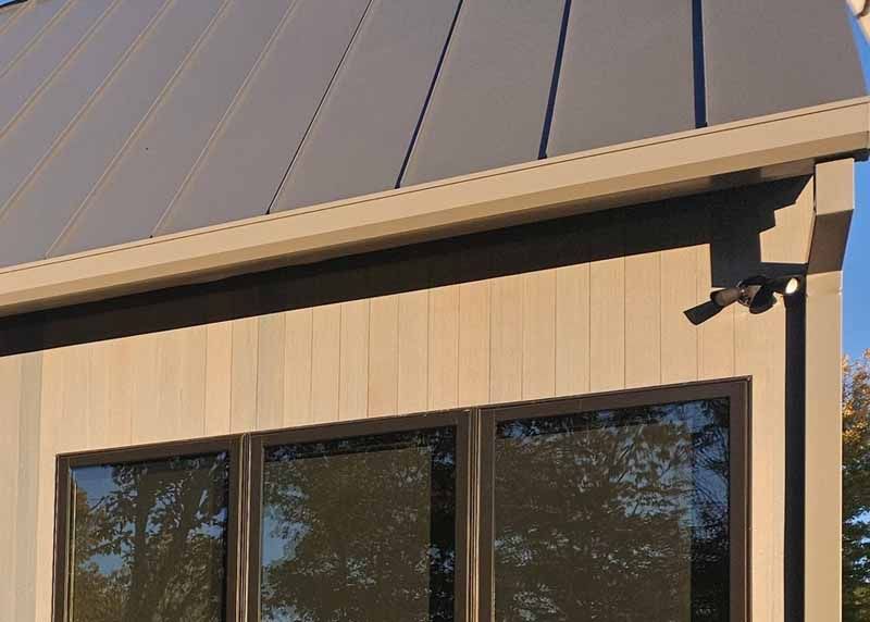 A house with a gray roof and a lot of windows