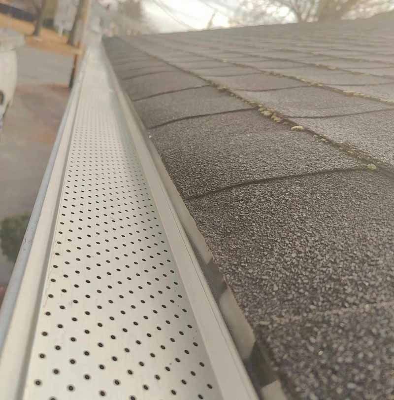 A close up of a gutter on a roof.