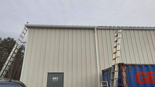 A large building with a ladder attached to the side of it.