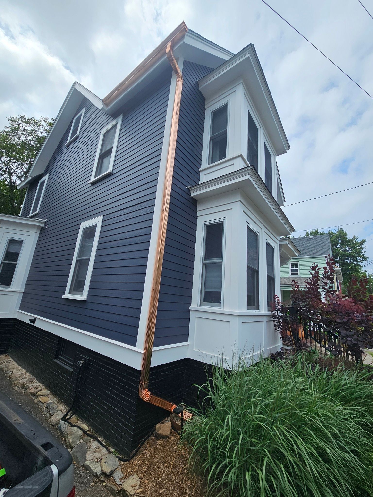 Seamless copper K- Style gutter and downspout installed on a Portsmouth, NH home by New England Gutter Systems