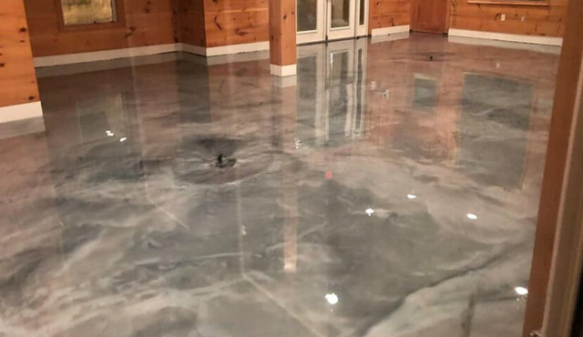 Polished marble lobby floor with water puddles and reflections near wooden walls and doors