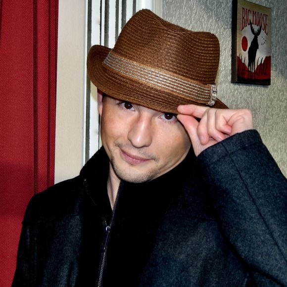 A professional photograph of Dustin Lee in sepia tones.